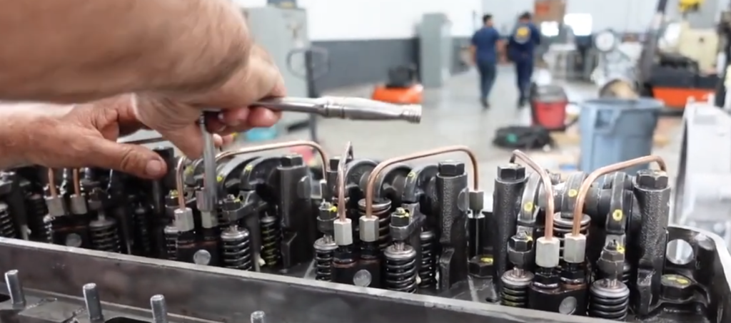 Technician Installing The Fuel Lines On A Detroit Diesel 671 Engine